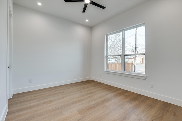 spare room featuring ceiling fan and light hardwood / wood-style floors