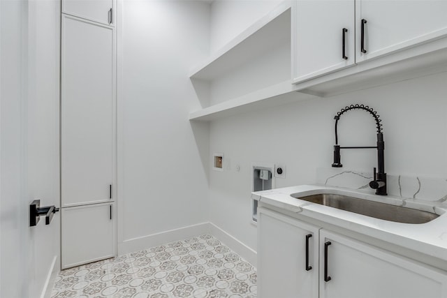 washroom with sink, cabinets, light tile patterned floors, electric dryer hookup, and washer hookup