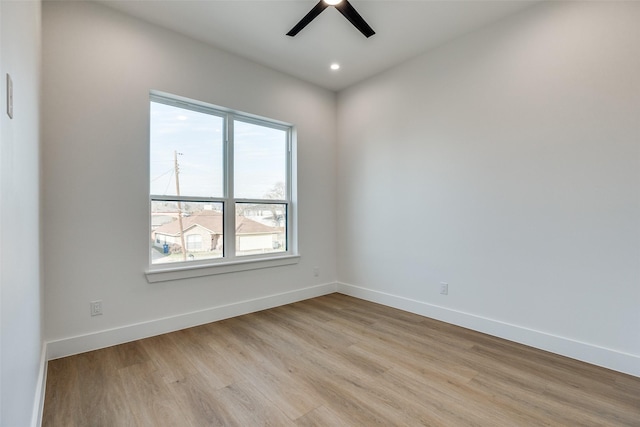 unfurnished room featuring light hardwood / wood-style floors and ceiling fan