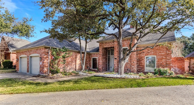 view of front of property featuring a garage and a front yard