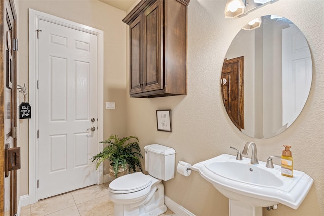 bathroom with tile patterned flooring, sink, and toilet