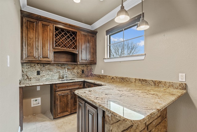 bar with pendant lighting, tasteful backsplash, sink, ornamental molding, and light stone countertops