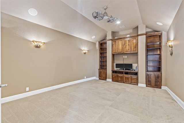 unfurnished living room featuring vaulted ceiling and carpet