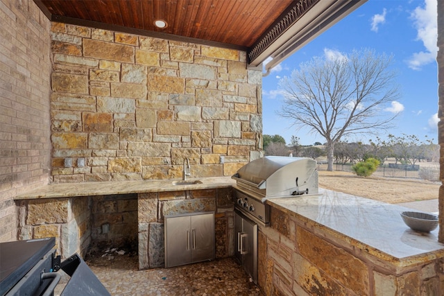 view of patio featuring an outdoor kitchen, sink, and area for grilling