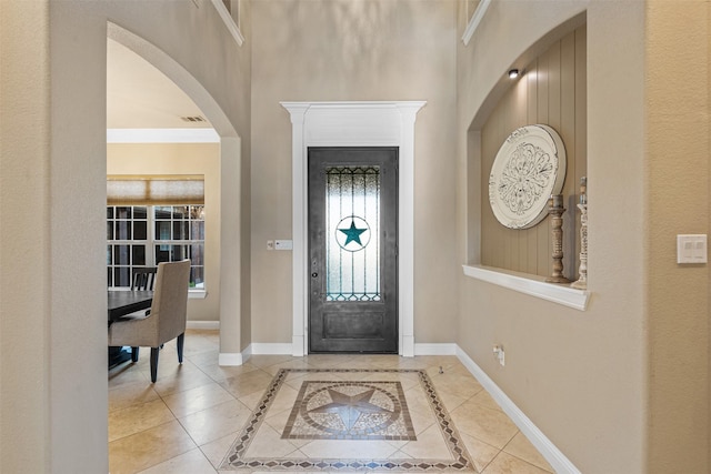 entryway featuring crown molding and tile patterned flooring