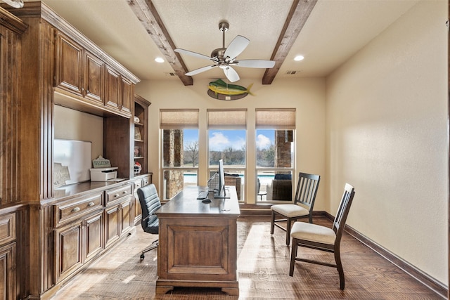 home office featuring hardwood / wood-style flooring, ceiling fan, and beam ceiling