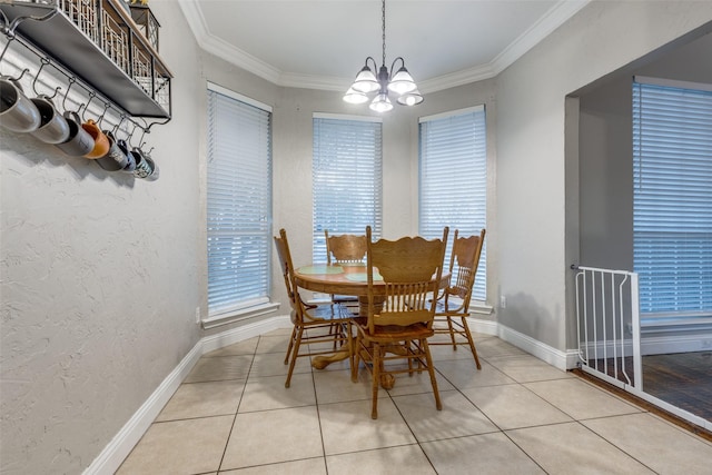 tiled dining room featuring crown molding and an inviting chandelier