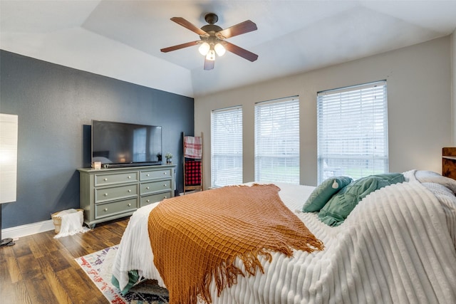 bedroom with lofted ceiling, dark hardwood / wood-style floors, and ceiling fan