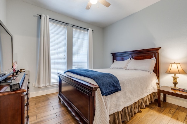 bedroom with light hardwood / wood-style floors and ceiling fan