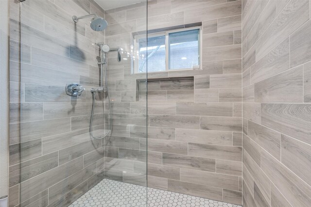 bathroom with tiled shower