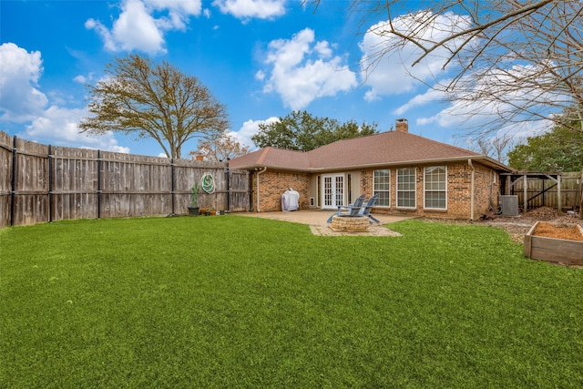 back of house with french doors, cooling unit, a lawn, and a patio area