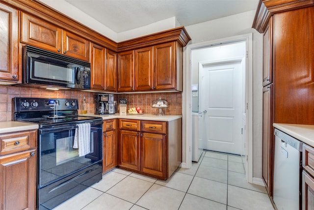 kitchen featuring light tile patterned floors, decorative backsplash, and black appliances