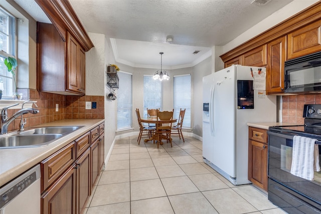 kitchen featuring pendant lighting, sink, ornamental molding, a notable chandelier, and black appliances