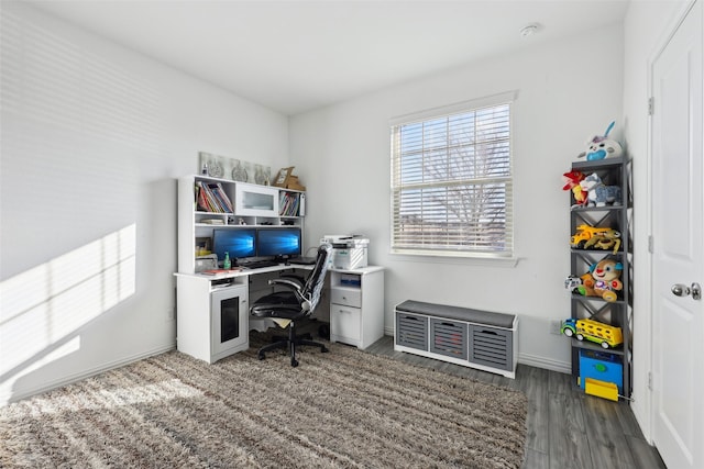 office with dark hardwood / wood-style flooring