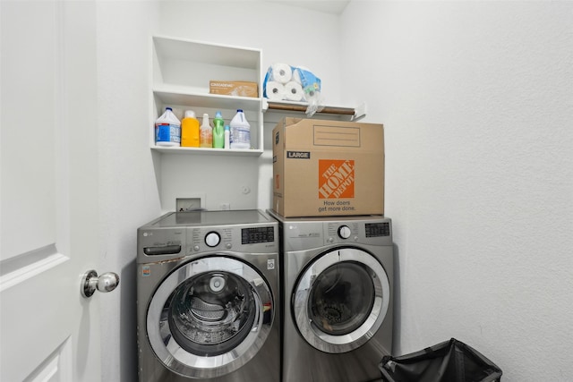 washroom featuring washing machine and clothes dryer