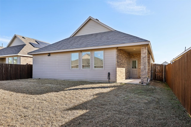 back of house with a yard