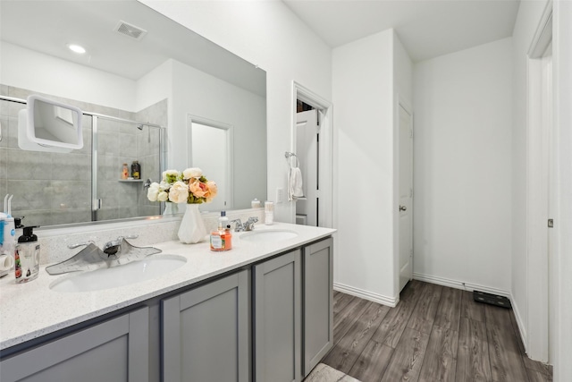 bathroom featuring an enclosed shower, vanity, and hardwood / wood-style flooring