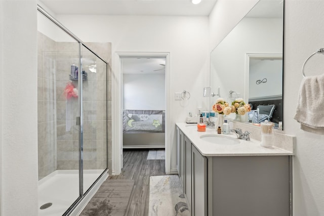 bathroom featuring hardwood / wood-style flooring, vanity, and an enclosed shower