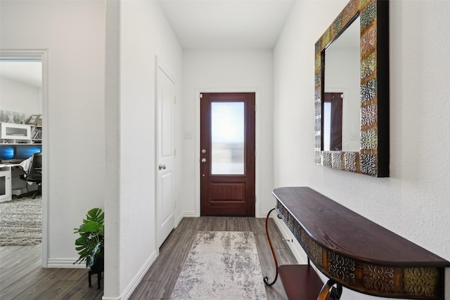 entryway with dark hardwood / wood-style flooring