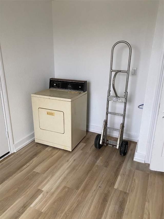 laundry area with washer / clothes dryer and light hardwood / wood-style flooring