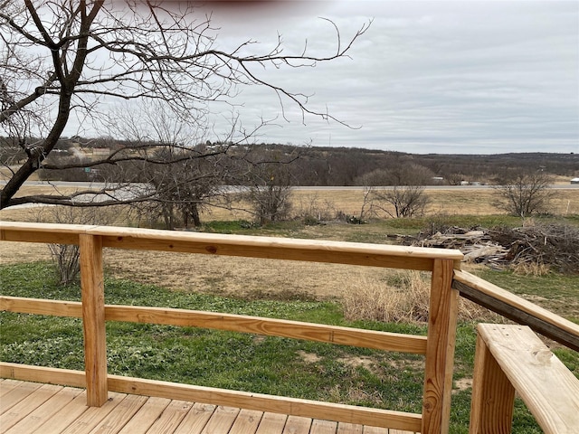 wooden deck with a rural view