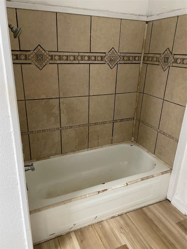 bathroom featuring a bath and hardwood / wood-style flooring