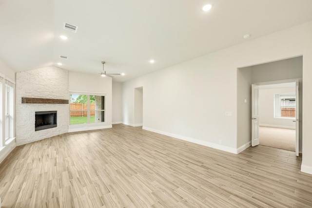 837 Rusty Run Dr, Midlothian, TX 76065 - unfurnished living room featuring ceiling fan, a fireplace, light wood-style flooring, vaulted ceiling, and baseboards