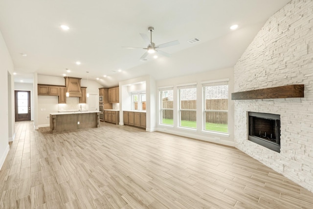 837 Rusty Run Dr, Midlothian, TX 76065 - unfurnished living room featuring lofted ceiling, a ceiling fan, a fireplace, baseboards, and light wood finished floors