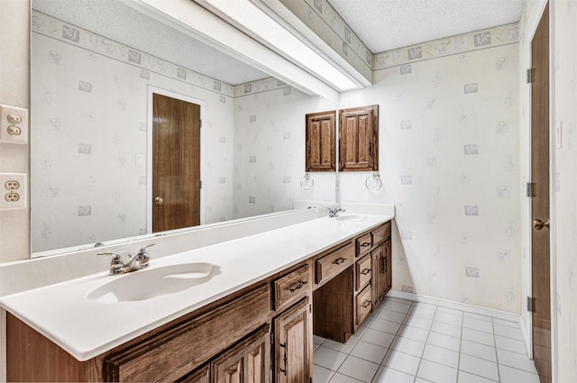 bathroom featuring tile patterned floors, vanity, and a textured ceiling