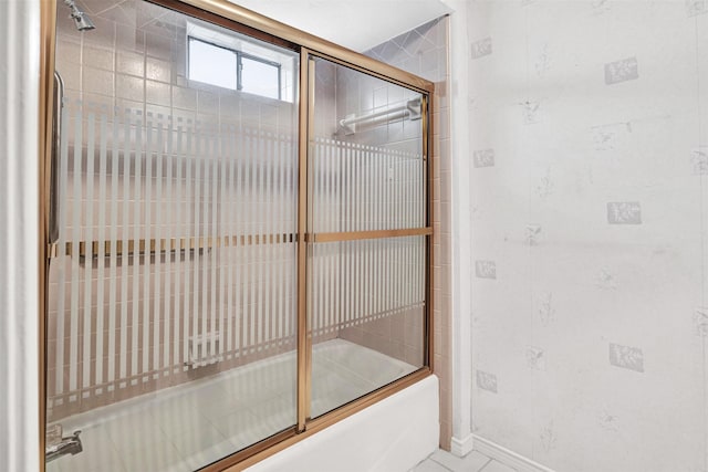 bathroom with shower / bath combination with glass door