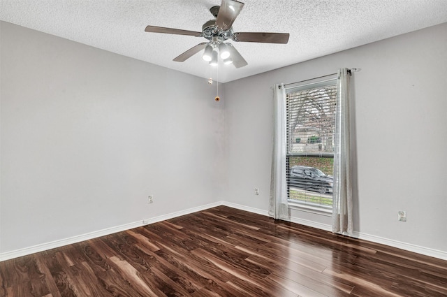 unfurnished room featuring dark hardwood / wood-style flooring, ceiling fan, and a textured ceiling