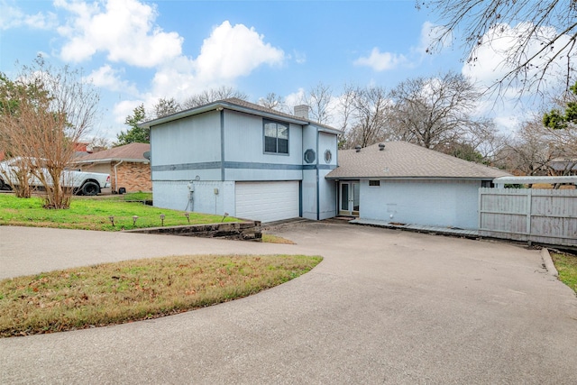 view of front of house featuring a garage and a front yard