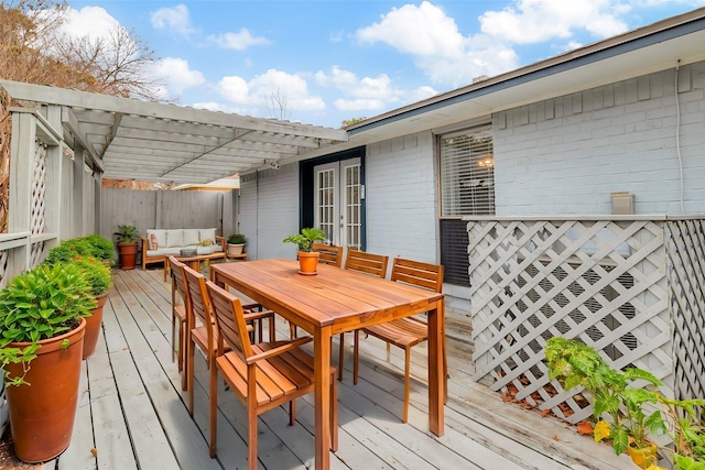 wooden terrace with an outdoor living space and a pergola