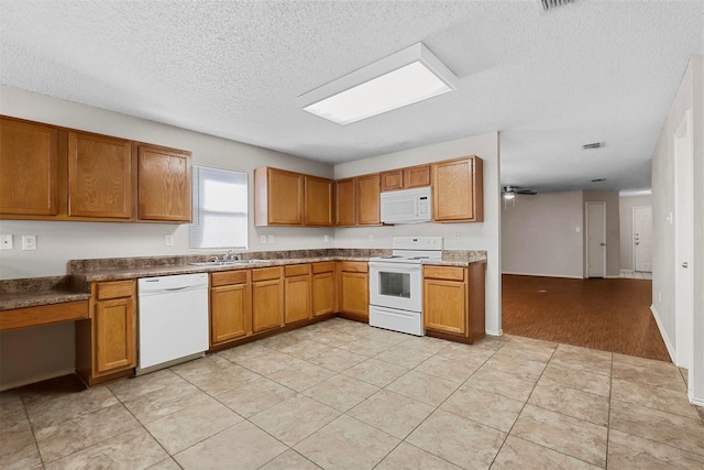 kitchen featuring sink, white appliances, a textured ceiling, light tile patterned floors, and ceiling fan