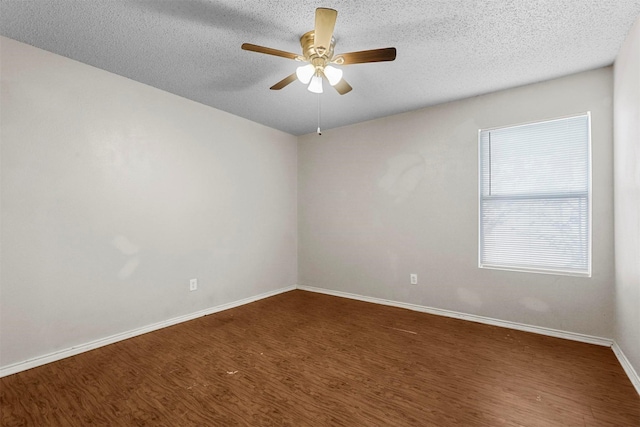 unfurnished room with dark wood-type flooring, a textured ceiling, and ceiling fan