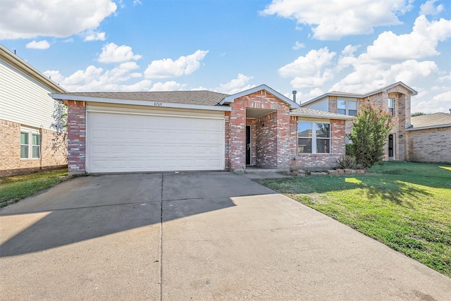 view of front of property with a garage and a front yard