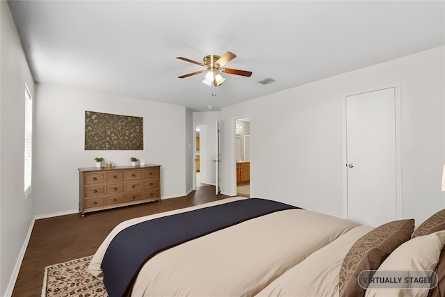 bedroom featuring ceiling fan, connected bathroom, and dark hardwood / wood-style floors