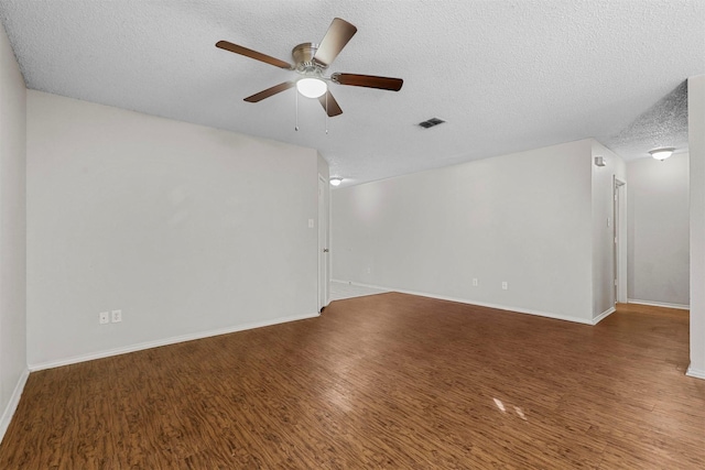 empty room featuring hardwood / wood-style flooring, ceiling fan, and a textured ceiling