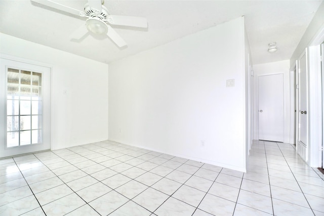 empty room featuring light tile patterned floors and ceiling fan