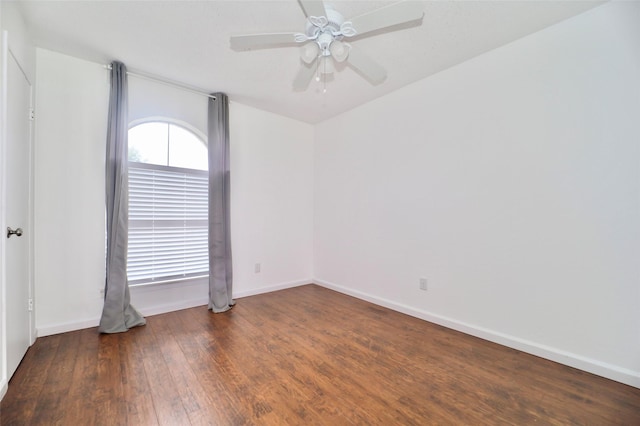 empty room featuring ceiling fan and dark hardwood / wood-style flooring