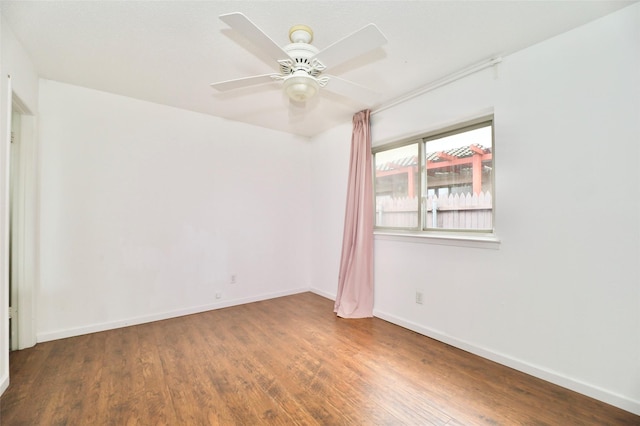 empty room featuring ceiling fan and hardwood / wood-style floors