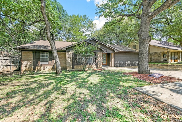 ranch-style home with a garage and a front lawn