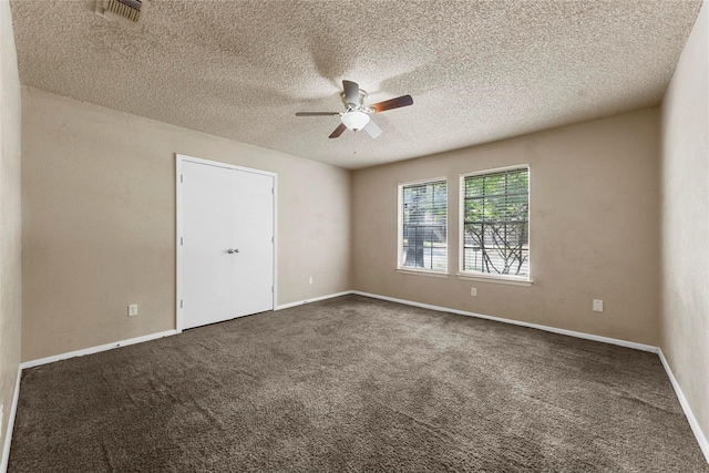 unfurnished room featuring dark colored carpet, a textured ceiling, and ceiling fan