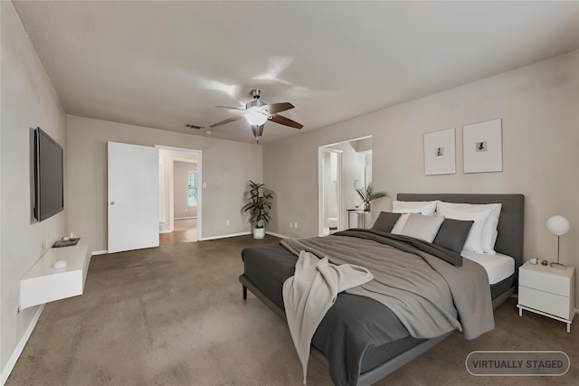 carpeted bedroom with ceiling fan and ensuite bath