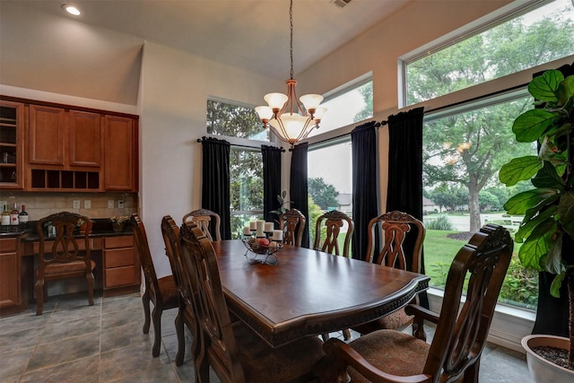 dining room with a high ceiling and a chandelier