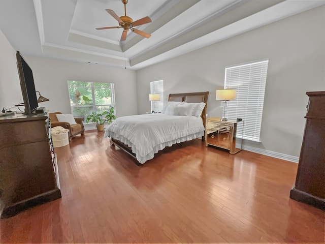 9801 Georgia Ave, Denton, TX 76207 - bedroom featuring a tray ceiling, wood finished floors, ceiling fan, and baseboards