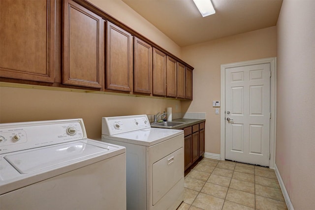 laundry room featuring washer and dryer, sink, light tile patterned floors, and cabinets