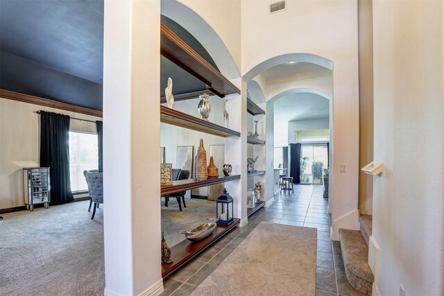 9801 Georgia Ave, Denton, TX 76207 - corridor featuring arched walkways, built in features, dark tile patterned flooring, and baseboards