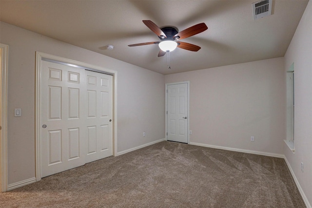 unfurnished bedroom featuring light colored carpet and ceiling fan