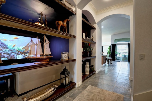 hallway with ornamental molding and built in features